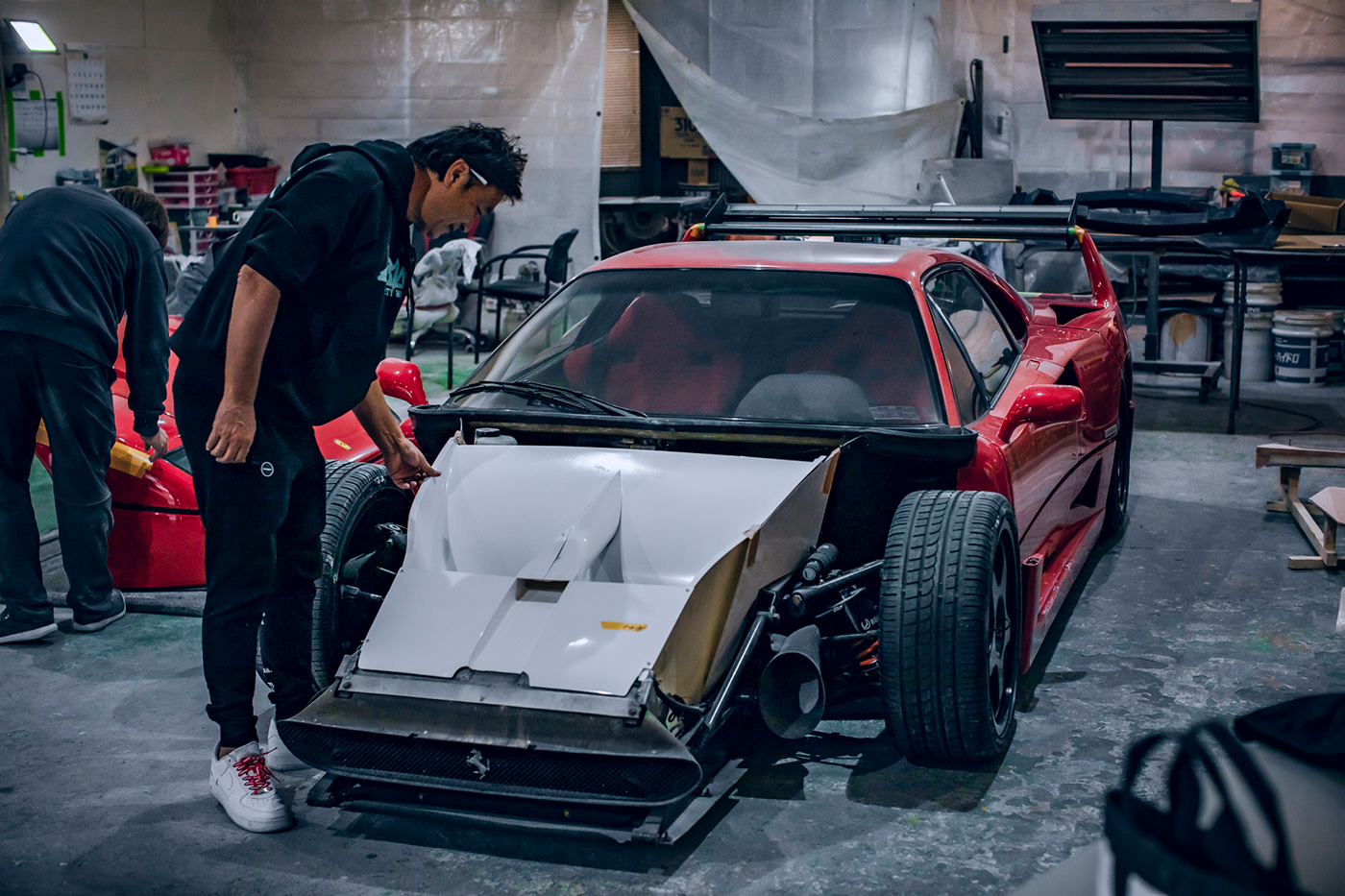 Kato-San inspects the hood of his meticulous Ferrari F40 build at Liberty Walk Headquarters in Japan.